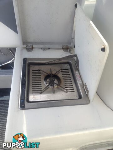 USED HAINES HUNTER 680C HALF CABIN WITH A 2005 SUZUKI 200HP 4 STROKE OUTBOARD ON A 2020 SWIFTCO DUAL AXLE TRAILER