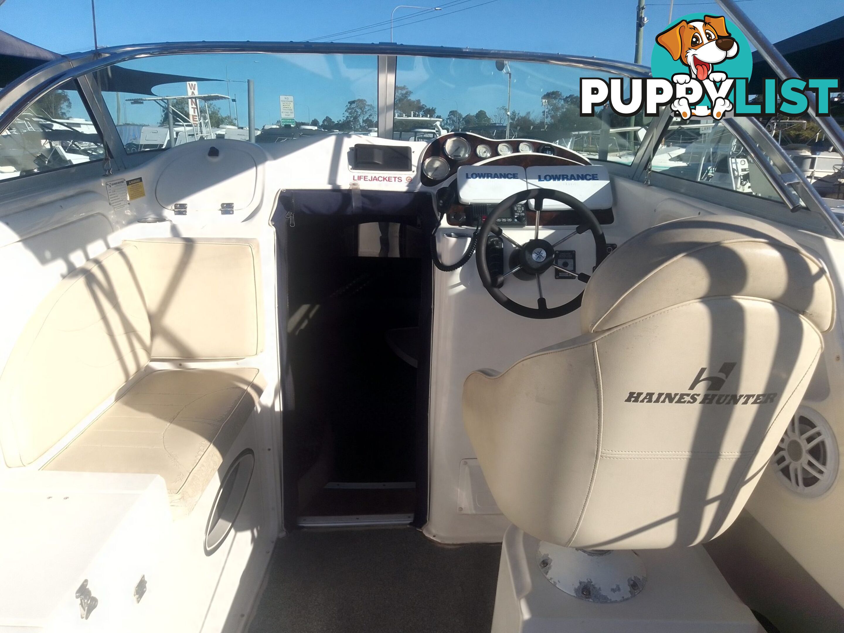 USED 2005 HAINES HUNTER 650 HORIZON HALF CABIN ON A 2005 EASYTOW DUAL AXLE TRAILER WITH A 215HP HONDA 4 STROKE OUTBOARD