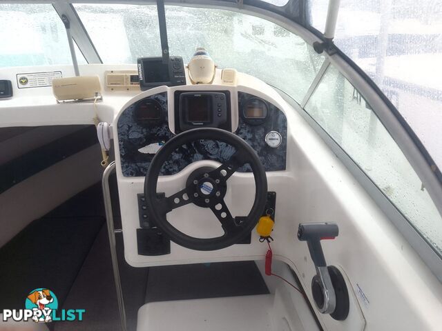 USED 2001 HAINES HUNTER 530 HALF CABIN ON A 2002 TINKA MULTI ROLLER TRAILER WITH A 115HP YAMAHA OUTBOARD.