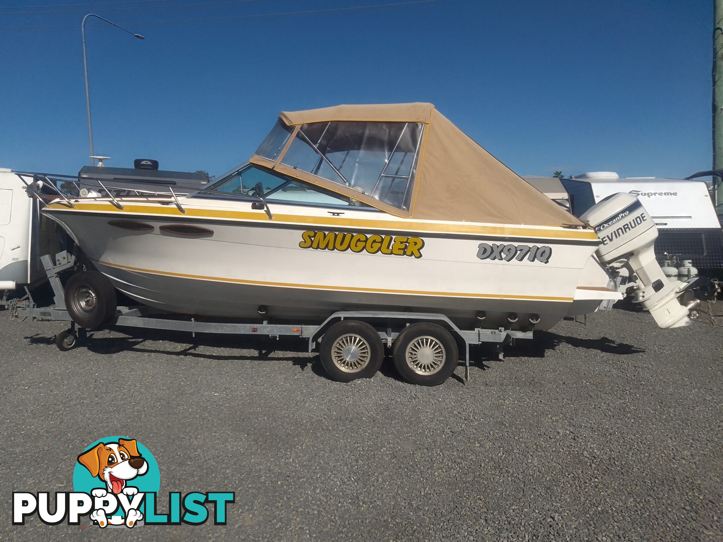 USED 1989 SMUGGLER 6.30 HALF CABIN WITH A 225HP V6 EVINRUDE OUTBOARD ON A 2000 MODEL DUAL AXLE TRAILER.