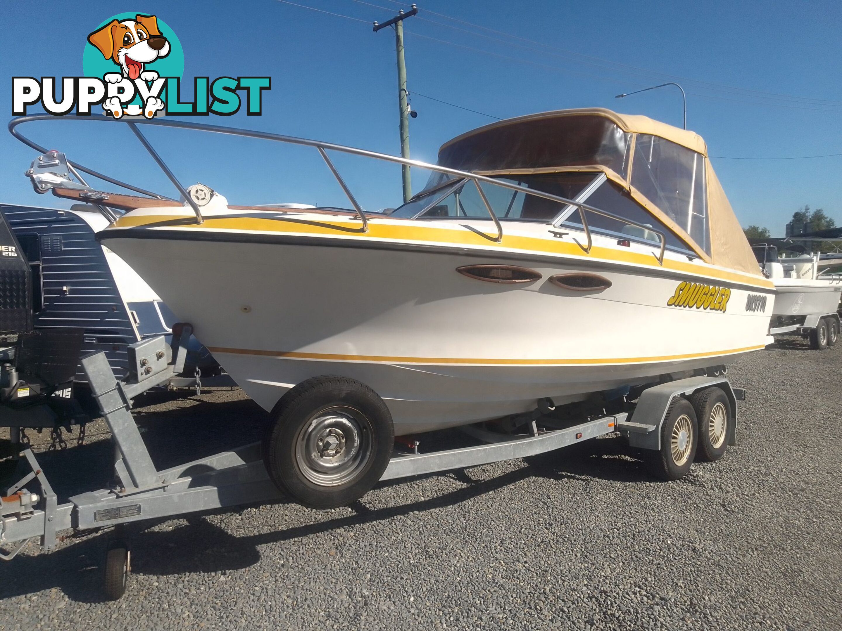 USED 1989 SMUGGLER 6.30 HALF CABIN WITH A 225HP V6 EVINRUDE OUTBOARD ON A 2000 MODEL DUAL AXLE TRAILER.