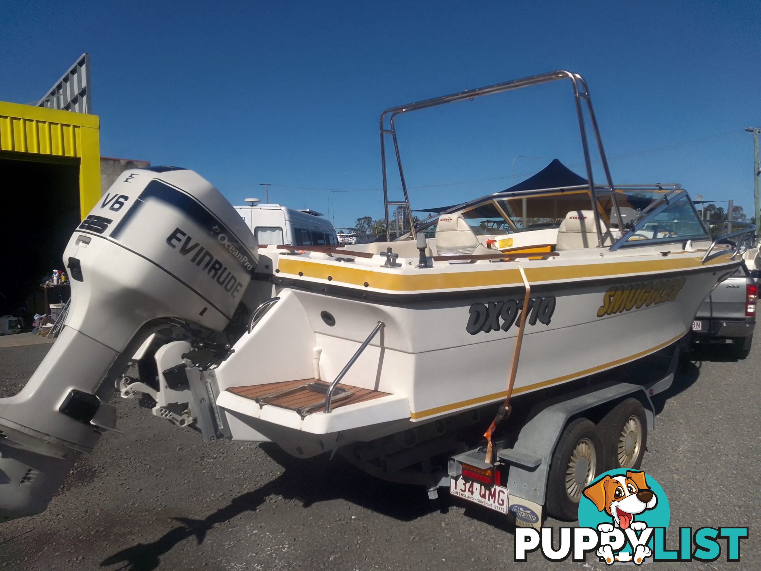USED 1989 SMUGGLER 6.30 HALF CABIN WITH A 225HP V6 EVINRUDE OUTBOARD ON A 2000 MODEL DUAL AXLE TRAILER.
