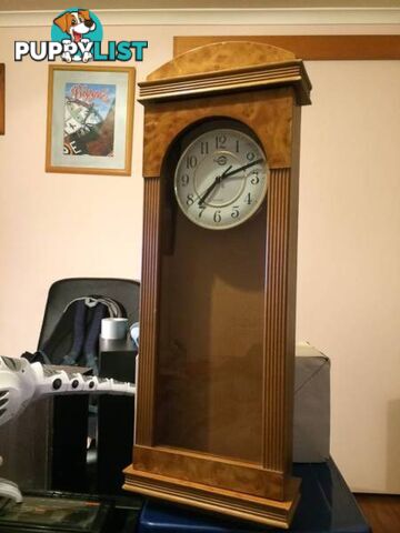 WALL MOUNTED CLOCK IN WOODEN CASE WITH GLASS DOOR