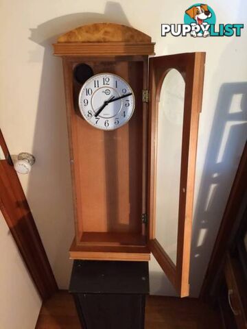 WALL MOUNTED CLOCK IN WOODEN CASE WITH GLASS DOOR