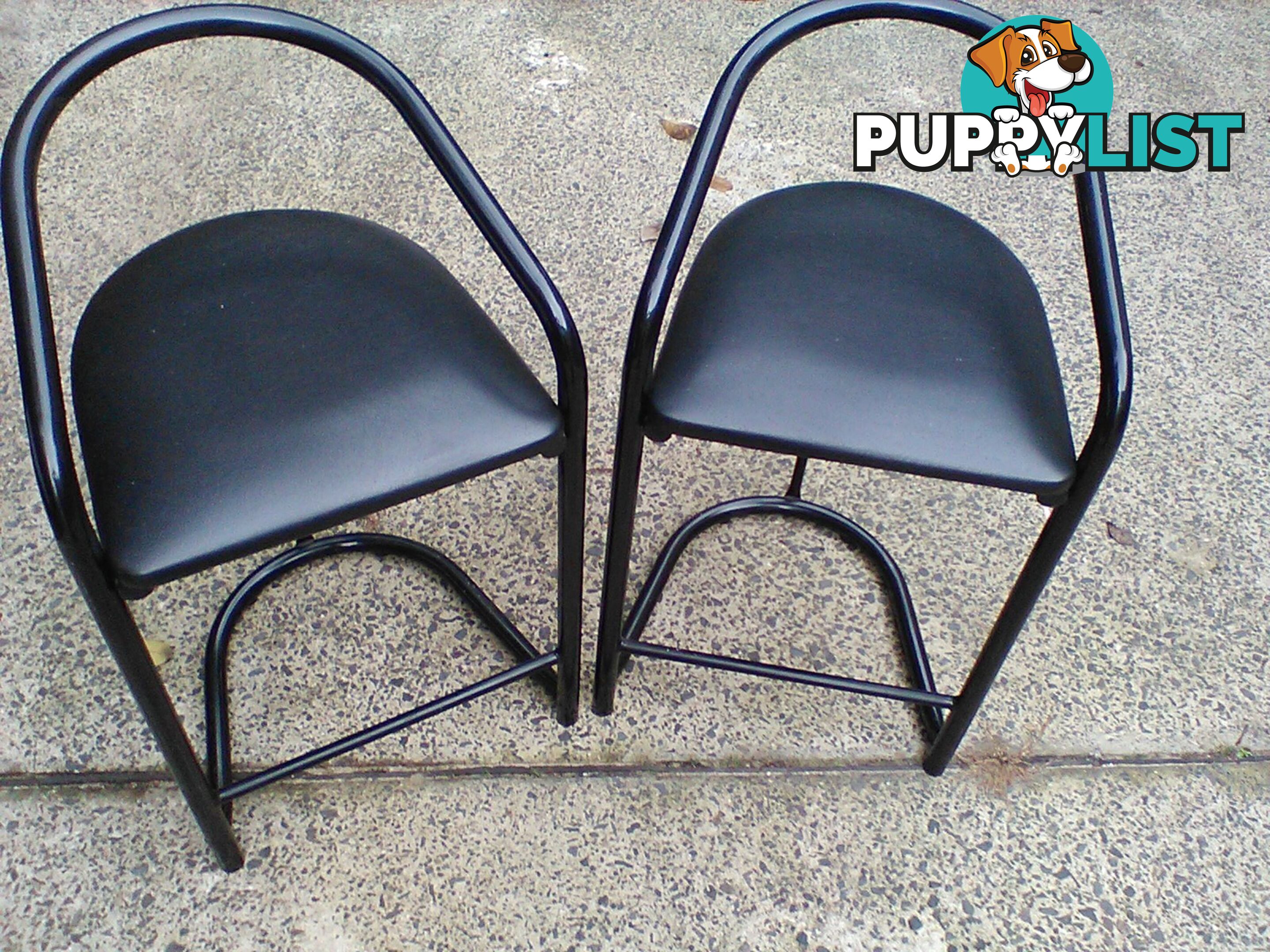Four black bar stools