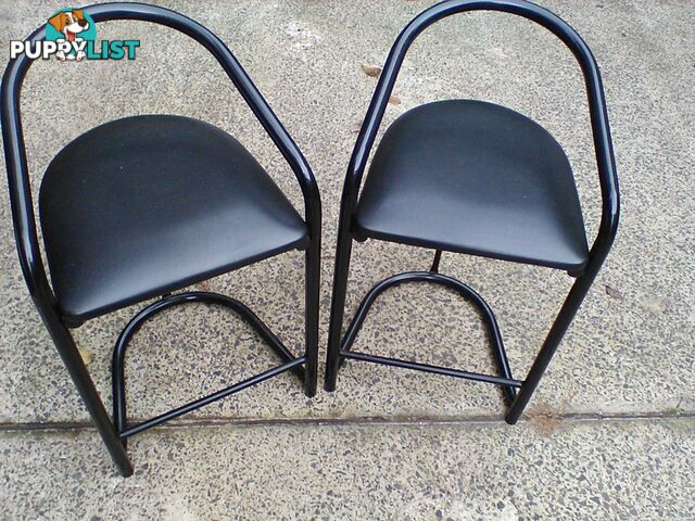 Four black bar stools