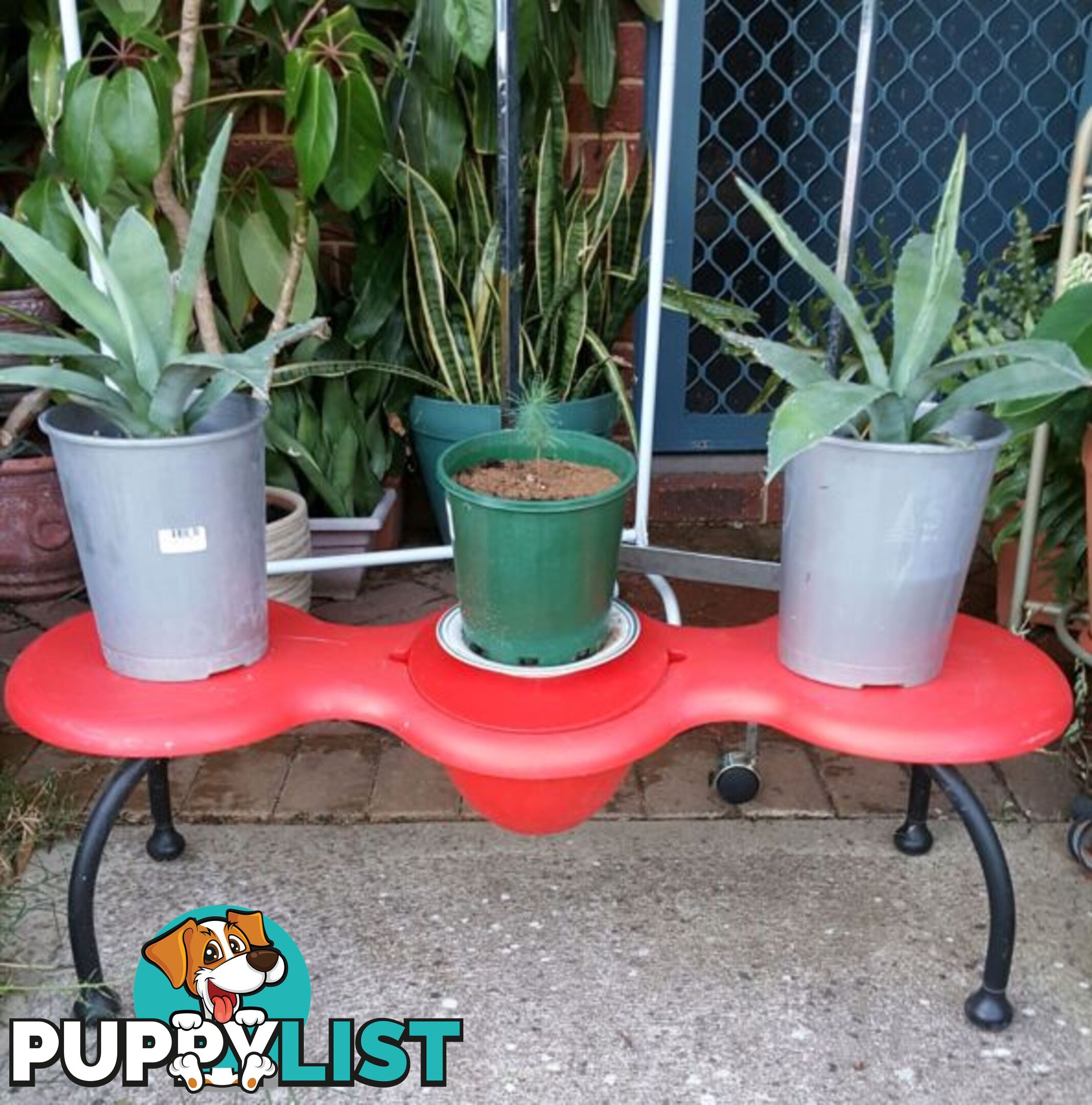 Red bench for flowers in pots