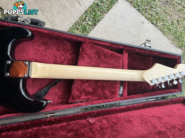Electric guitar, small amp and hard case
