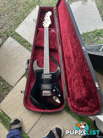 Electric guitar, small amp and hard case
