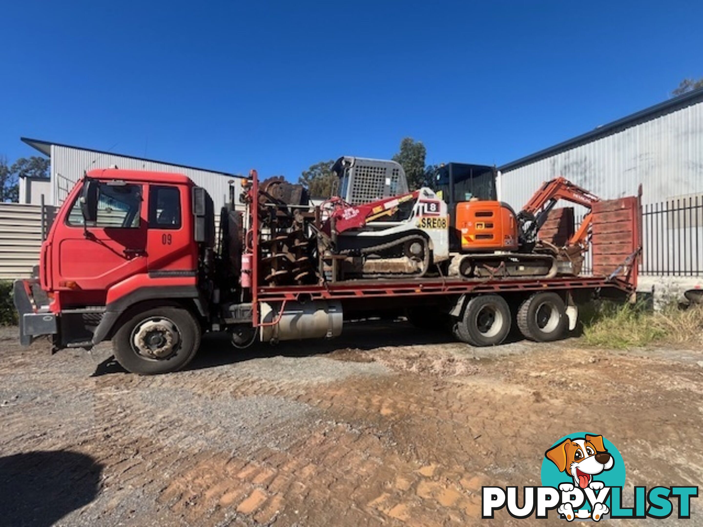 2022 5.5T Hitachi exc, attachments, 75HP TL8 positrak on a Nissan UD flatbed with hydraulic ramps