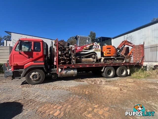 2022 5.5T Hitachi exc, attachments, 75HP TL8 positrak on a Nissan UD flatbed with hydraulic ramps