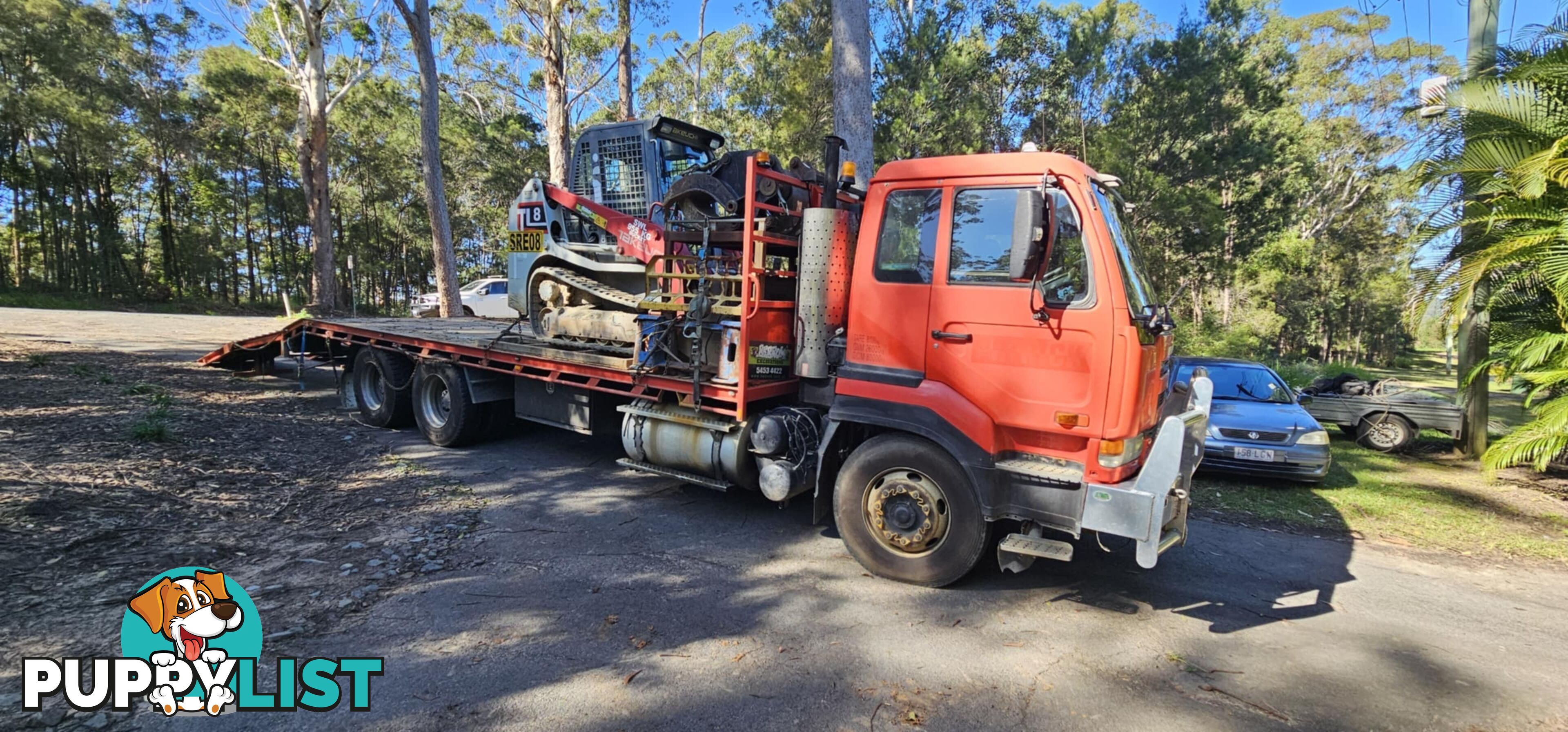 2022 5.5T Hitachi exc, attachments, 75HP TL8 positrak on a Nissan UD flatbed with hydraulic ramps