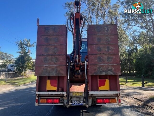 2022 5.5T Hitachi exc, attachments, 75HP TL8 positrak on a Nissan UD flatbed with hydraulic ramps