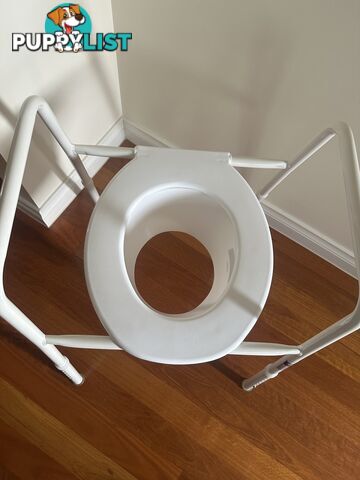 Over toilet seat rails and splash guard