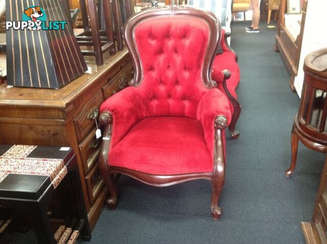 Wingback armchair in gorgeous red with carved timber frame