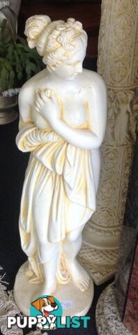 Garden statue of lovely Grecian goddess lady on pedestal