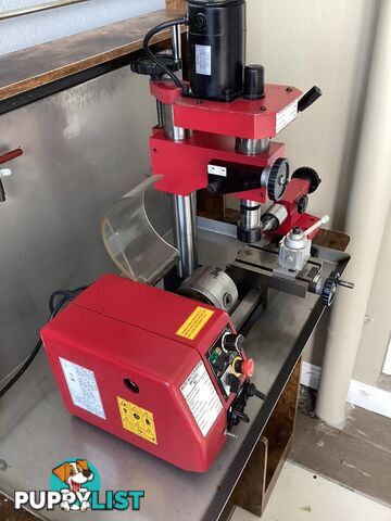 bench lathe with 3 jaw chuck and vertical milling attatchment.